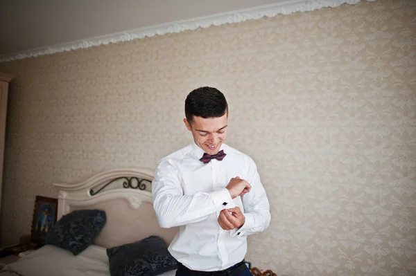 Handsome groom dressing up and getting ready for his wedding in — Stock Photo, Image