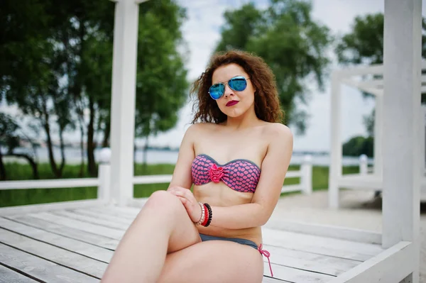 Retrato de uma menina atraente posando em biquíni com óculos de sol — Fotografia de Stock