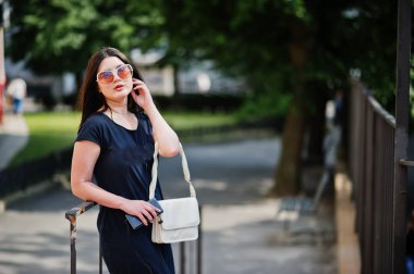 Siyah elbise, güneş gözlüğü h üzerinden müzik dinlemek, esmer kız