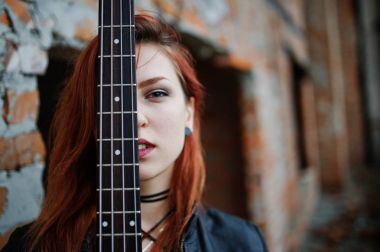 Kırmızı saçlı punk kız giyim siyah ile abadoned, bas gitar 