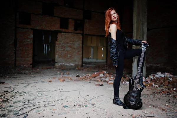Red haired punk girl wear on black with bass guitar at abadoned — Stock Photo, Image