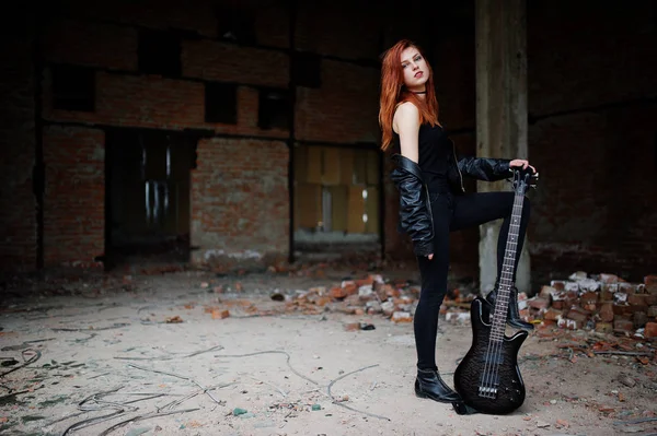 Red haired punk girl wear on black with bass guitar at abadoned — Stock Photo, Image