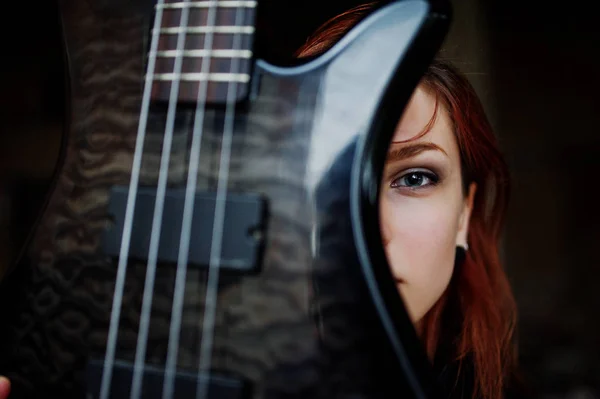 Red haired punk girl wear on black with bass guitar at abadoned — Stock Photo, Image