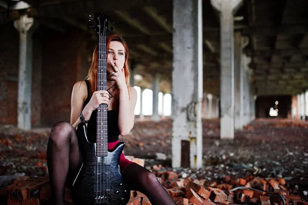 Red haired punk girl wear on black and red skirt, with bass guit — Stock Photo, Image