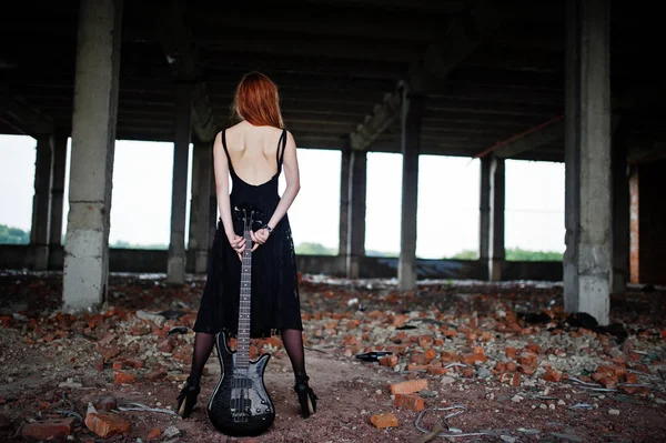 Rojo chica punk pelo desgaste en negro con bajo guitarra en abadoned —  Fotos de Stock