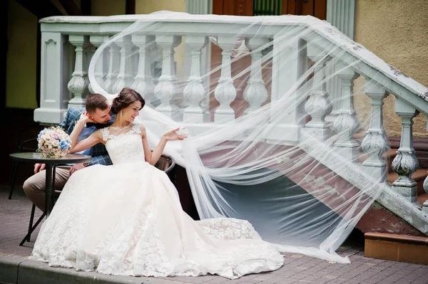 Fiatal gyönyörű esküvői pár ül az üveg asztal egy — Stock Fotó