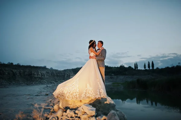 Schönes Hochzeitspaar hält Händchen und schaut einander an — Stockfoto