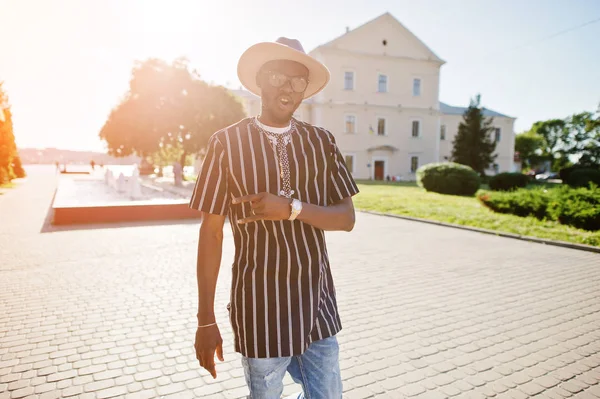 Vonzó afrikai amerikai férfi csíkos ing, kalap és sungla — Stock Fotó