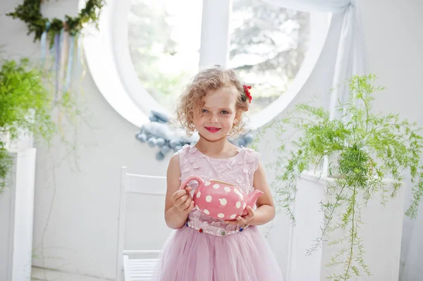 Portrait of an adorable little girl in lovely dress holding a pi — Stock Photo, Image