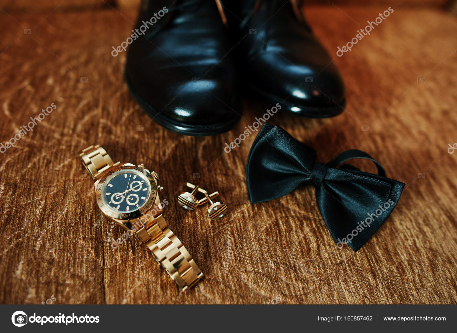 Groom's wedding black shoes, golden watch, bow tie and cufflinks