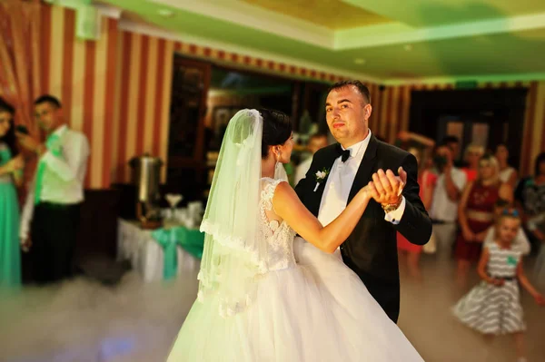 Beautiful couple dancing in the restaurant with different lights — Stock Photo, Image