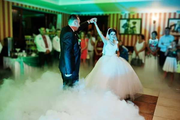 Beautiful couple dancing in the restaurant with different lights — Stock Photo, Image