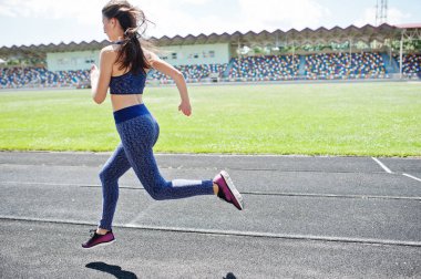 Spor giyim stadi içinde çalışan güçlü bir uygun kız portresi
