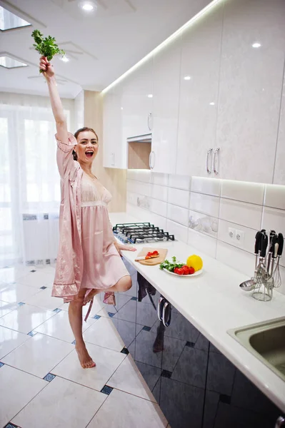 Portrait of a gorgeous young woman in pink robe posing with pars — Stock Photo, Image