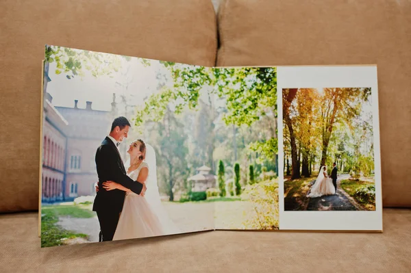 Sidor av bröllop fotobok eller bröllop album i soffan med cus — Stockfoto