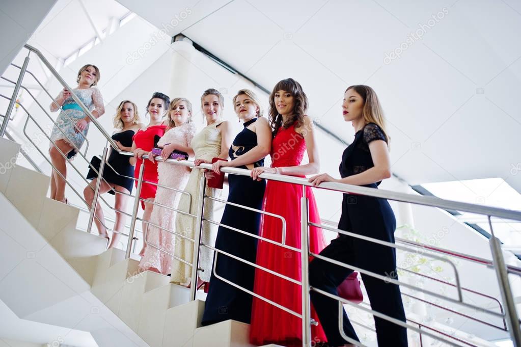 Group of outstandingly beautiful ladies in dresses posing on the