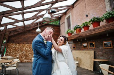 Genç evli iki yanındaki eski kır evi inci üzerinde yürüyor.