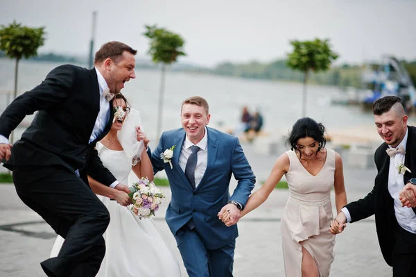 Amazing wedding couple and crazy groomsmen with bridesmaids havi