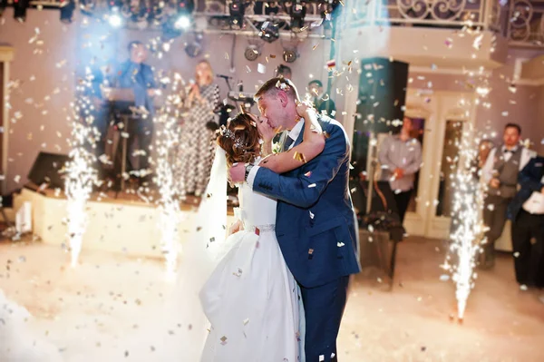 Newly married couple dancing on their wedding party with heavy s