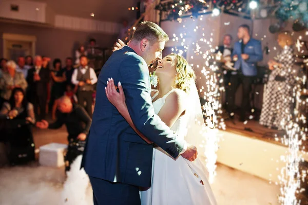 Newly married couple dancing on their wedding party with heavy s