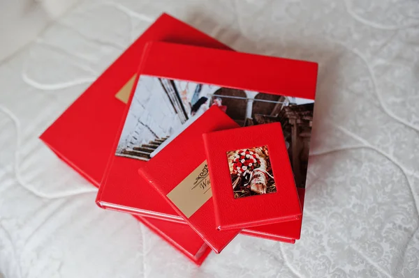 Elegant red wedding photobooks or photo albums with golden inscr