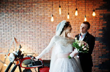 Muhteşem Düğün çifti bir ro büyük bir eski Motosiklet ile poz