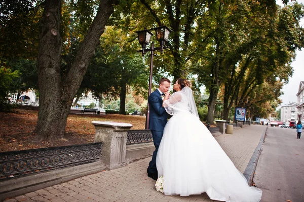 Good-looking newly married couple walking and enjoying each othe