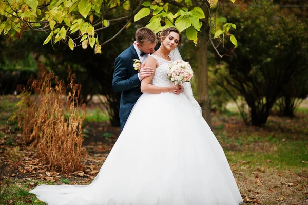 Good-looking newly married couple walking and enjoying each othe