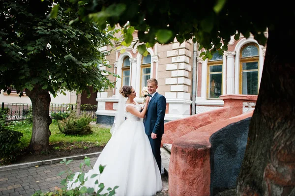 Good-looking newly married couple walking and enjoying each othe