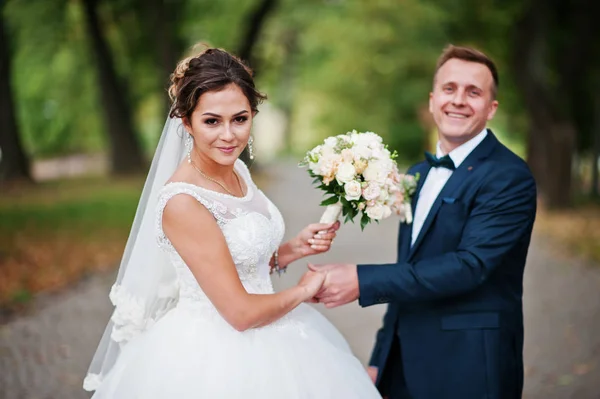 Good-looking newly married couple walking and enjoying each othe