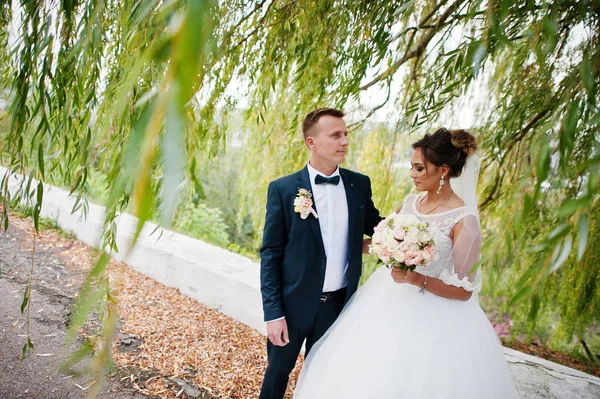 Good-looking newly married couple walking and enjoying each othe