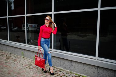 Kırmızı bluz ve kot posin muhteşem genç bir kadın portresi