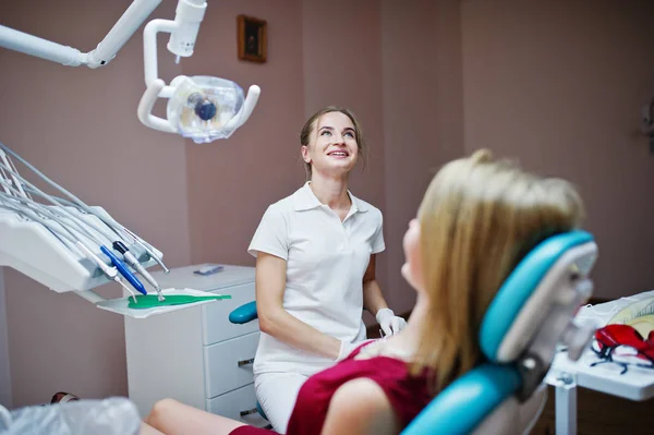 Bezaubernde Zahnärztin posiert und lächelt mit ihrem schönen Pati — Stockfoto