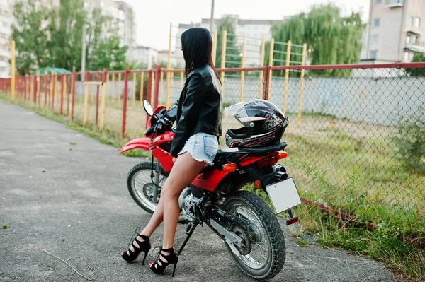 Portrait of a cool and awesome woman in dress and black leather