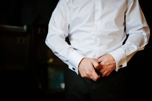 Portrait of a good-looking groom dressing up for his wedding.