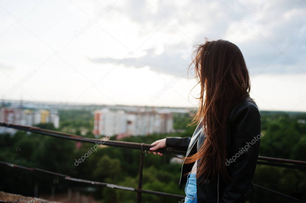 Portrait of an attractive young woman in black leather jacket, j