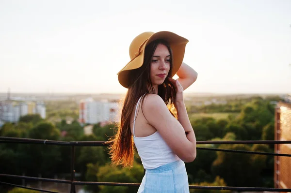 Portret van een mooie jonge vrouw in wit t-shirt en blauwe rokje — Stockfoto