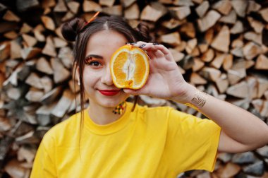 Genç kız parlak makyajlı, sarı gömlek giymek tutun 