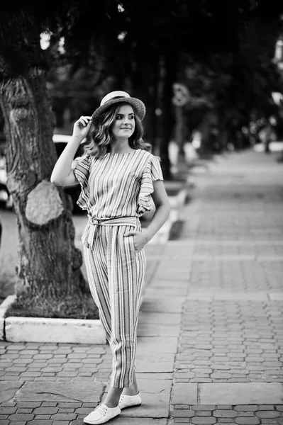 Portrait of a very attractive young woman in striped overall pos — Stock Photo, Image