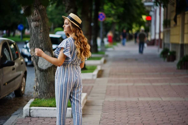 Portrait of a very attractive young woman in striped overall pos — Stock Photo, Image
