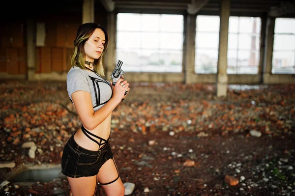 Girl wear on shorts and black erotic fetish underwear with gun a — Stock Photo, Image
