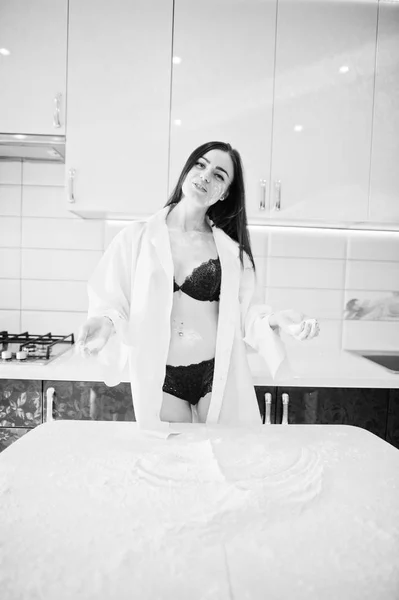 Brunette girl, wear at shirt and underwear play with flour at th — Stock Photo, Image