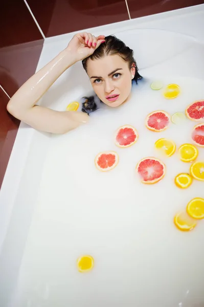Sexy brunette girl at the bathroom with milk and fruits. Youth b — Stock Photo, Image
