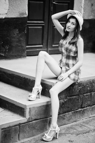 Şaşırtıcı uzun bacaklı hig topuklu kız ile sta üzerinde oturan şapka giymek