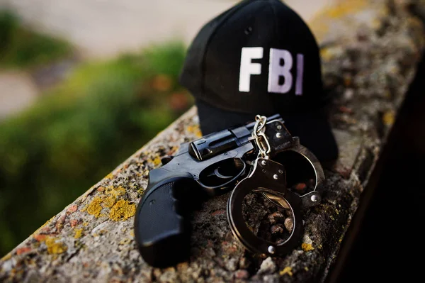 FBI kap ile tabanca ve kelepçe.