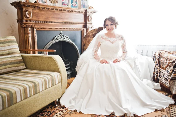 Portrét nevěsty v bílých svatebních šatech seděl v křesle v — Stock fotografie