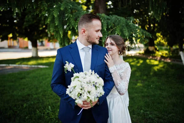 Maravillosa joven pareja de boda posando al aire libre en un hermoso sol —  Fotos de Stock