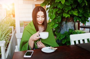 Kafe kapak ekose masaya oturan güzel esmer kız 