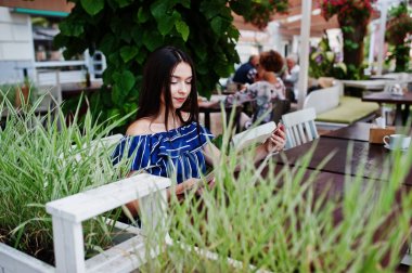 Kafede masada oturan ve seyir güzel esmer kız 