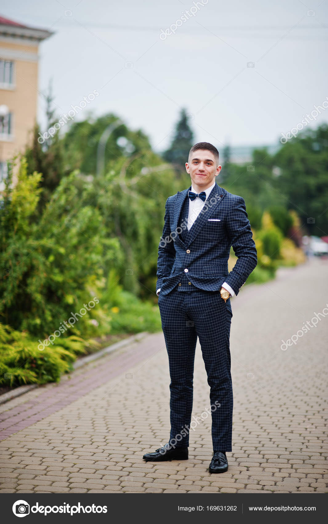 Portrait of a handsome young man in formal fancy suit posing on Stock Photo  by ©ASphoto777 169631262